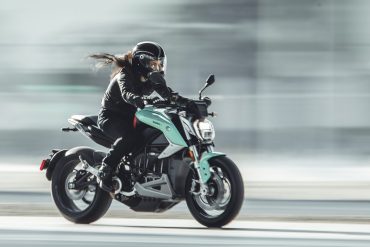 Woman on motorcycle travelling at speed